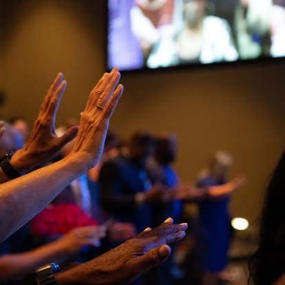 Bridgeway Community Church members worshipping with hands raised