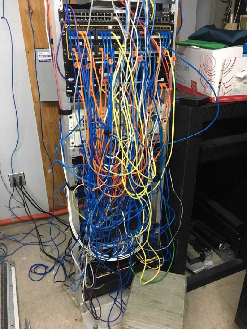 Tangled, disorganized cabling and hardware before the systems rebuild